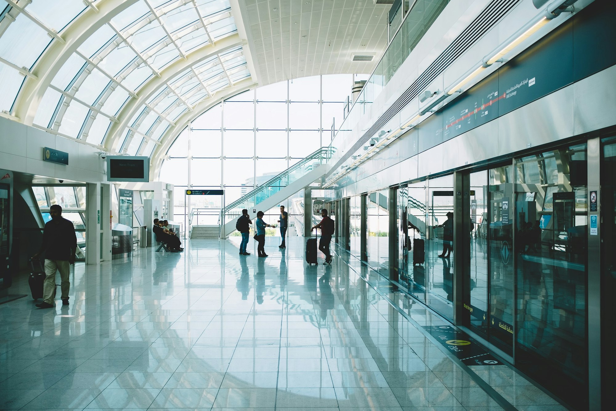Travellers moving through a bright, high-ceilinged concourse — What Scent Actually Does to Dwell Time and Spend